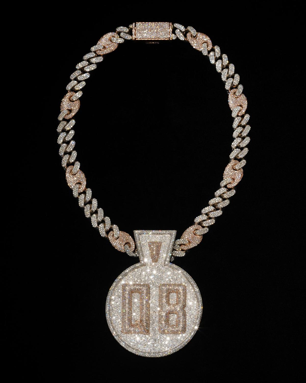 Featuring white and rose gold, this custom diamond-encrusted Queensbridge pendant was commissioned from Pristine Jewelers by Nas in 2018 to commemorate Queensbridge Houses in Queens, New York, where he grew up.